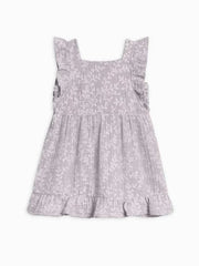 Jane Muslin Dress with ruffle hem and square neckline, featuring delicate wooden buttons and floral design.
