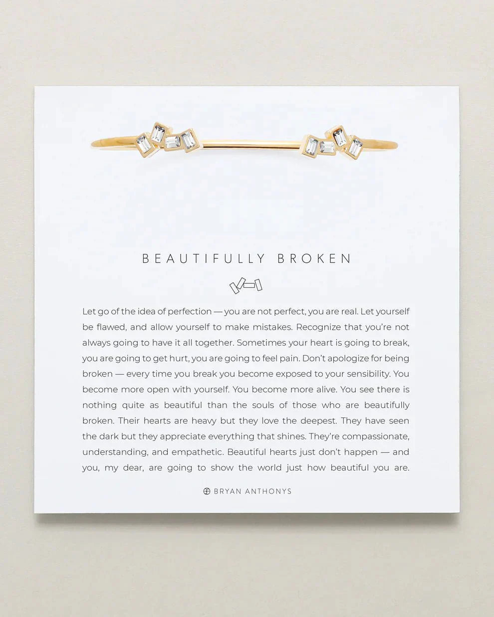 Adjustable "Beautifully Broken Cuff" in brass with 14k gold finish, emphasizes imperfection and resilience.