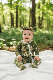 Baby Girl in Green Floral Outfit Outdoors