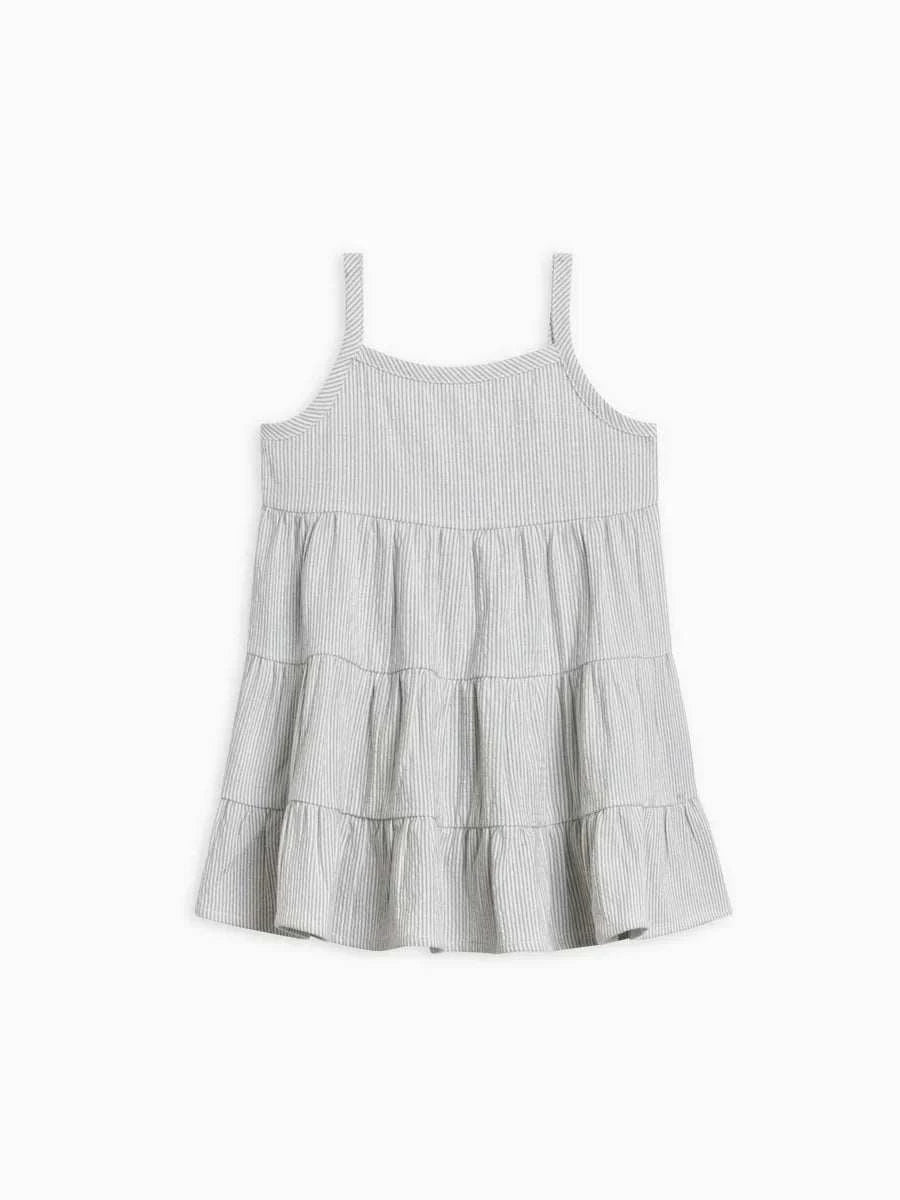 Organic cotton seersucker tiered dress with gathered waist and wooden button closure.