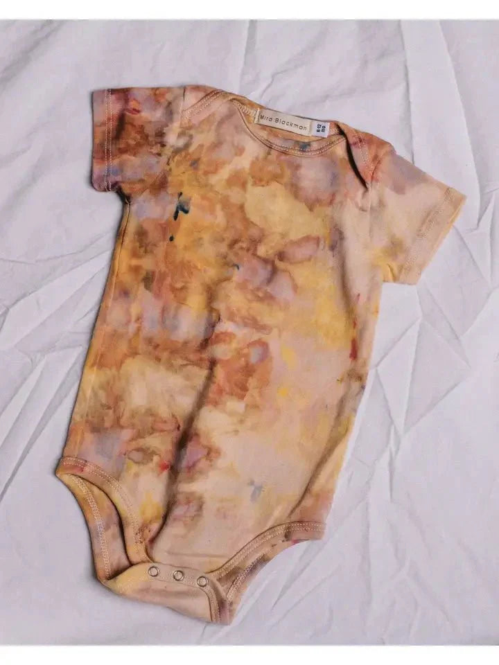 Organic Desert Sunset Onesies featuring unique hand-dyed patterns on 100% organic cotton with convenient 3 snap closure.