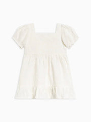 Briar Eyelet Puff Sleeve Dress for children in white organic cotton with puff sleeves and ruffle hem.