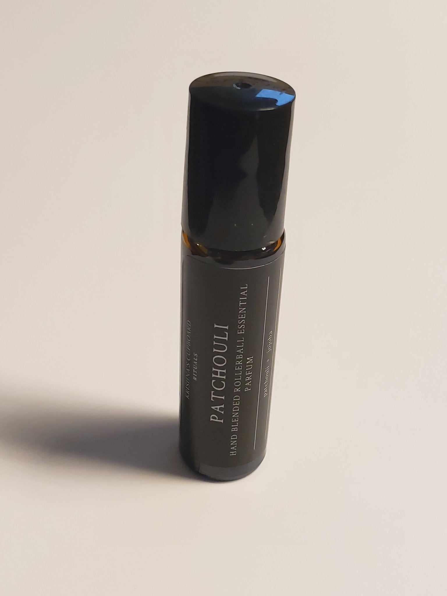 Patchouli Roll-On bottle with organic essential oil for a natural, earthy fragrance.