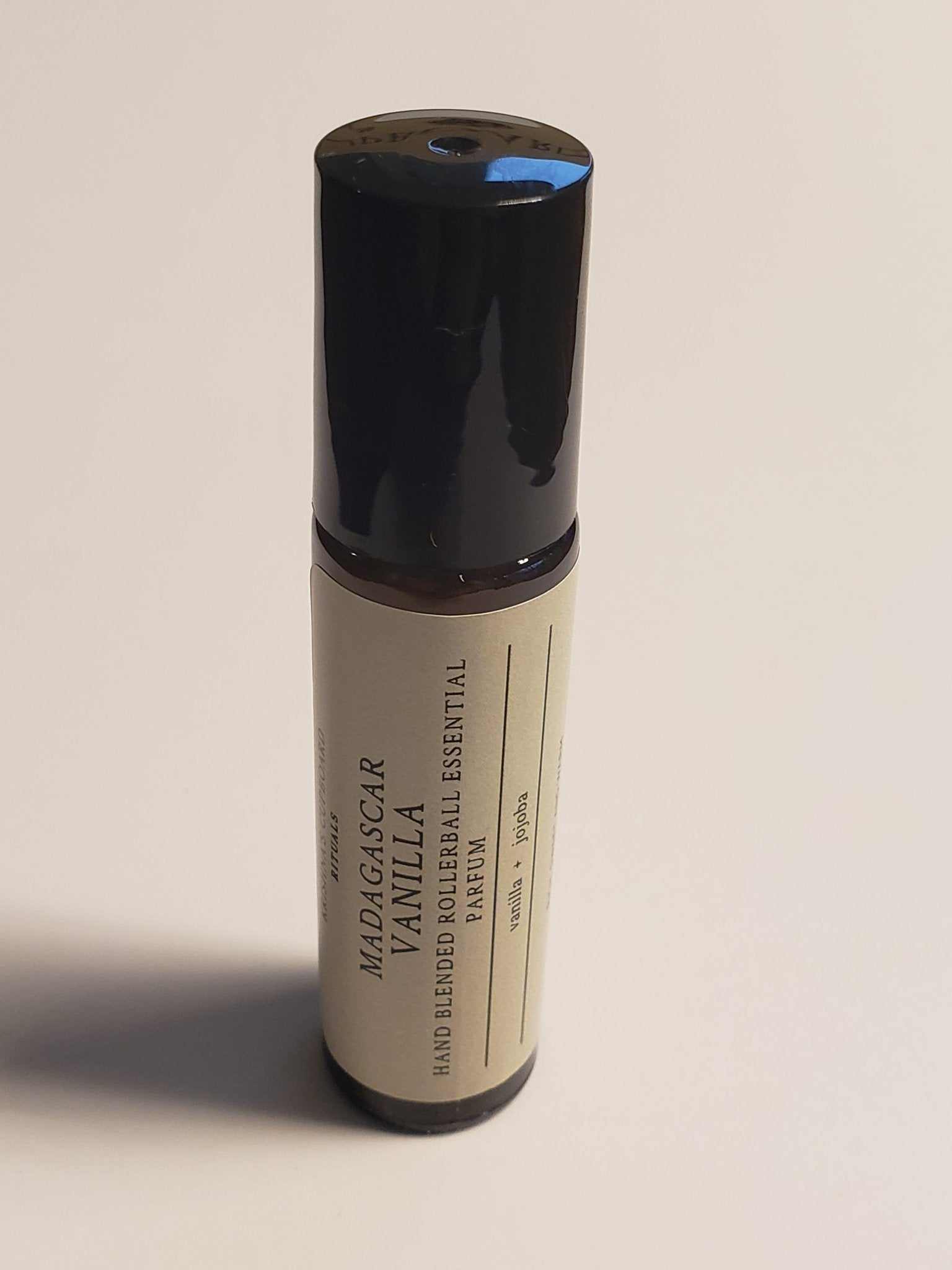 Madagascar Vanilla Roll-On bottle with black cap and label featuring essential oil details.