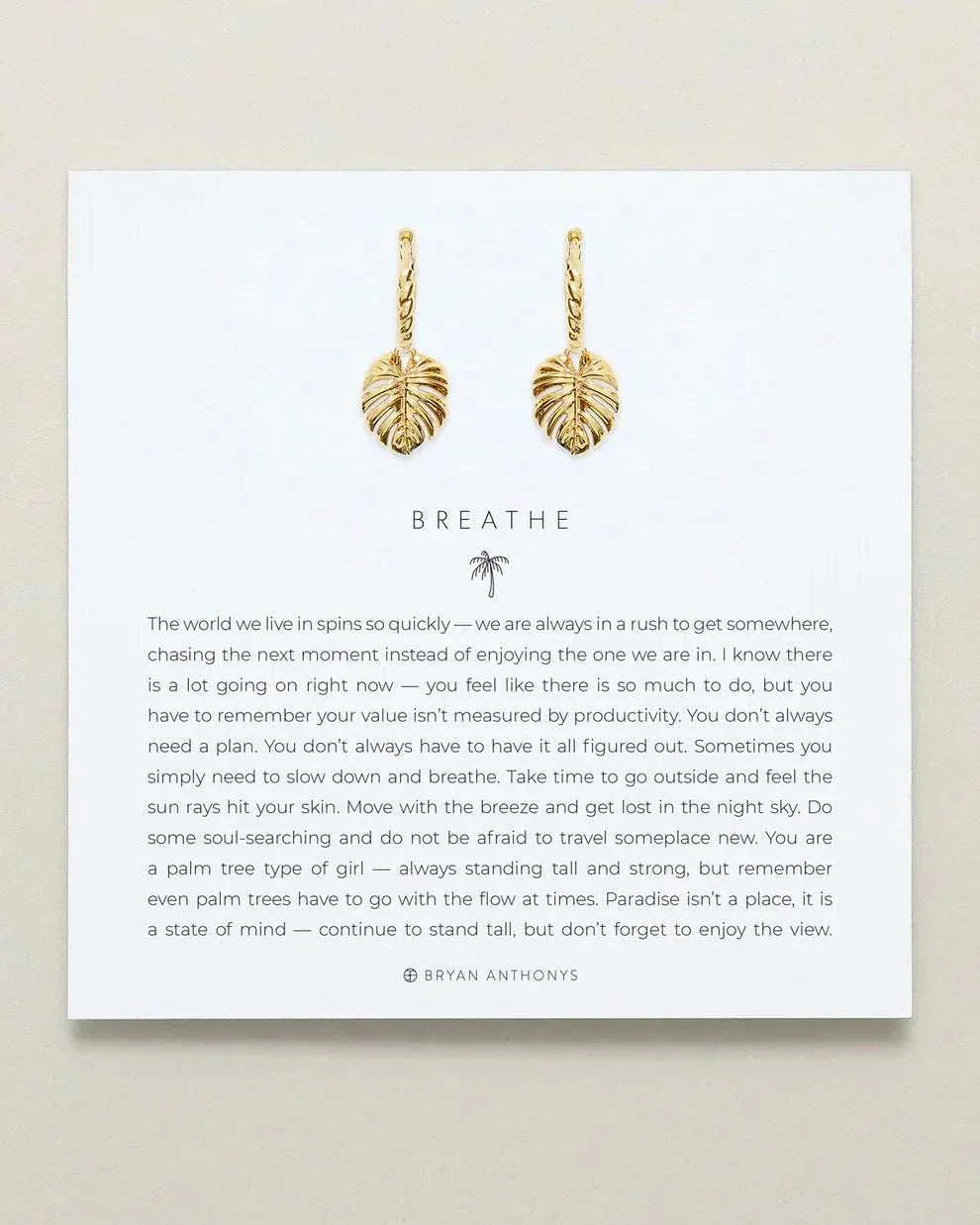 Elegant gold leaf huggie earrings by Bryan Anthonys enhancing the design of BREATHE HUGGIES with sophistication and style.