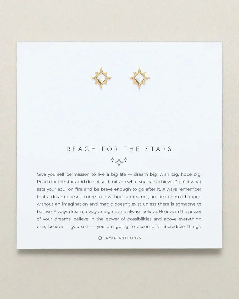 REACH FOR THE STARS earrings by Bryan Anthonys, gold star-shaped design on display card.