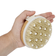 Castor Oil Lymphatic Dry Brush in hand for skincare enhancement.