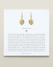 Elegant gold leaf huggie earrings by Bryan Anthonys enhancing the design of BREATHE HUGGIES with sophistication and style.