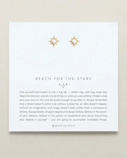 REACH FOR THE STARS earrings by Bryan Anthonys, gold star-shaped design on display card.